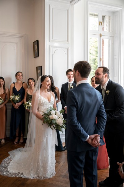 Bride groom guests seated and celebrant at alter during ceremony